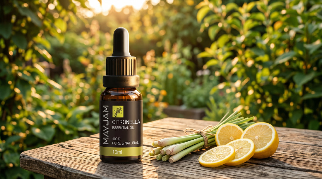 Mayjam Citronella essential oil on an outdoor table at golden hour with lemongrass and lemon