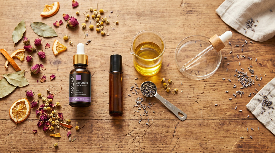 Top-down flat-lay of Mayjam essential oil, roller bottle and carrier oil for diluting